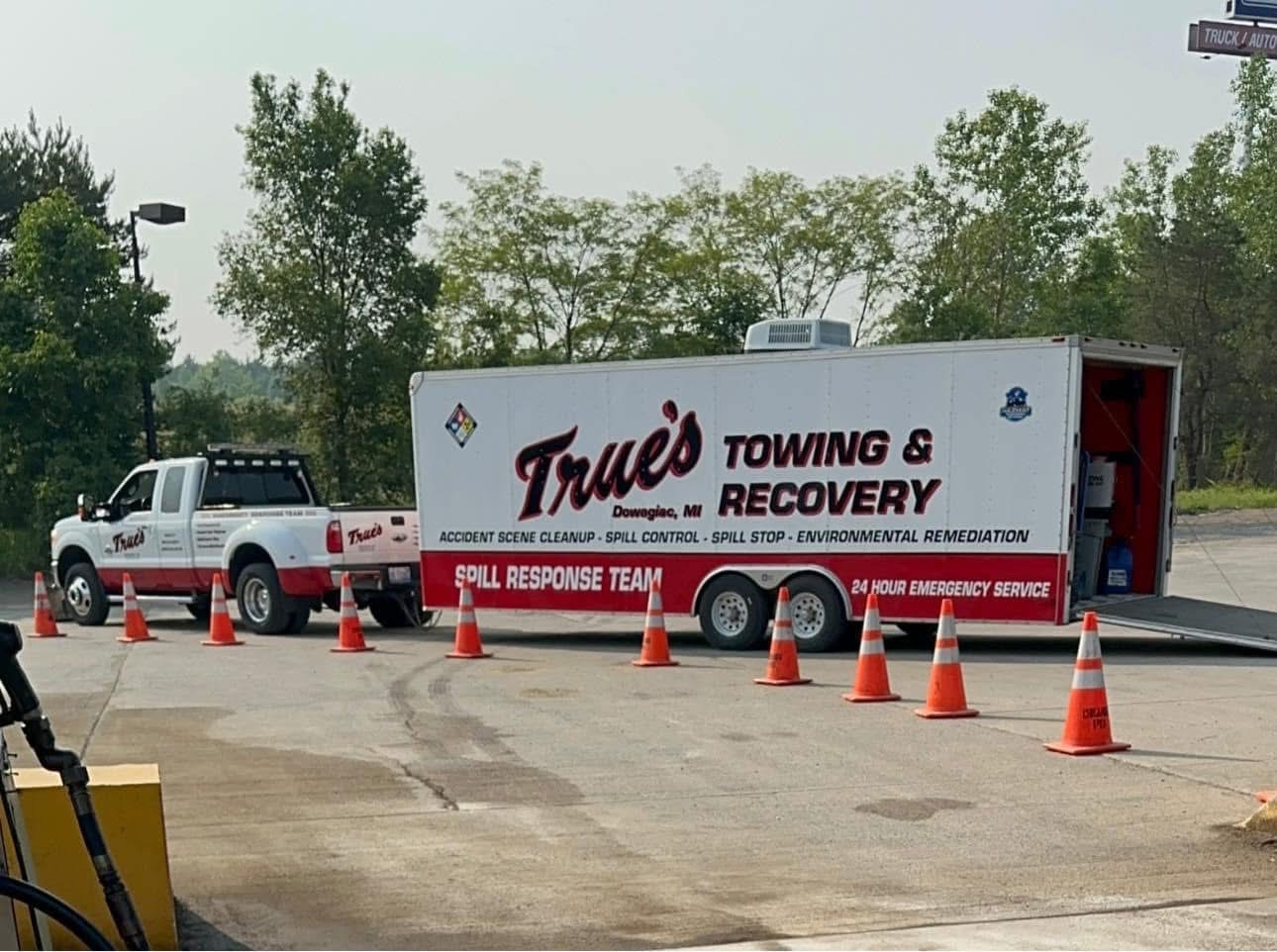 Tracked skid steer with a large winch box on the front for towing and recovery.